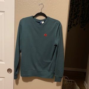Divided men’s sweater with rose accent